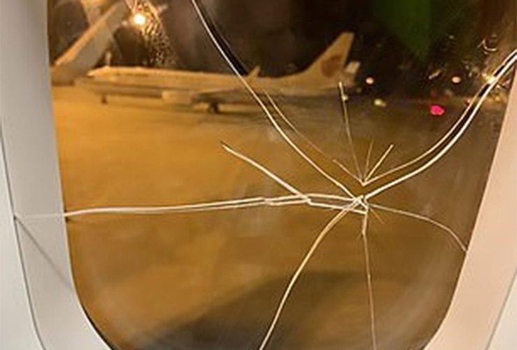 Close-up of the airplane window after being shattered