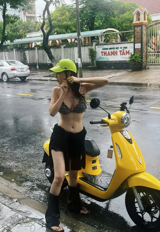 The buzz around images of a pretty girl in a bikini, innocently checking in on the street: Attractive outfit but inappropriate 3 Beautiful girl in bikini enjoying her time during the rain.