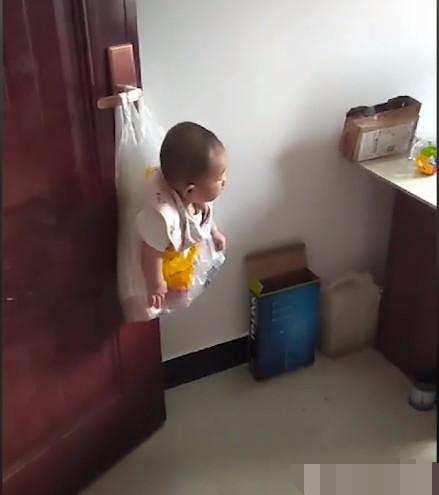 Đứa trẻ bị treo lủng lẳng trên tay cầm cửa trong túi ni lông
